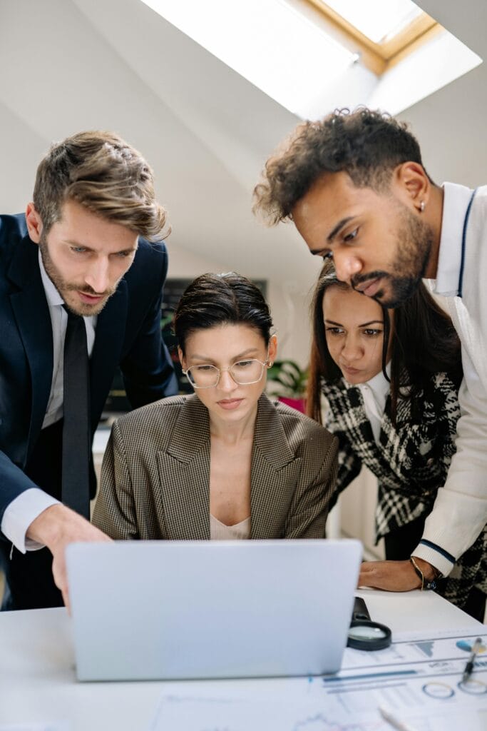A team of professionals with diverse backgrounds scanning through the leads submitted on a business referral networking website